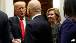 Deputy National Security Adviser Mira Ricardel, right, watches as President Donald Trump arrives for a Diwali ceremonial lighting of the Diya in the Roosevelt Room of the White House, Nov. 13, 2018, in Washington. 