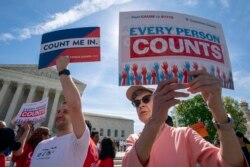 FILE - Immigration activists rally outside the Supreme Court as the justices hear arguments over the Trump administration's plan to ask about citizenship on the 2020 census, in Washington, April 23, 2019.