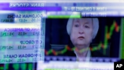 The news conference of Federal Reserve Chair Janet Yellen is reflected in a specialist's screen on the floor of the New York Stock Exchange, June 15, 2016.