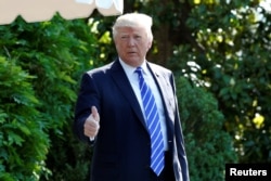 U.S. President Donald Trump gestures as he walks on the South Lawn of the White House in Washington, DC, U.S., before his departure to Groton, Connecticut, May 17, 2017.