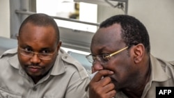 FILE - Chadema party chairman Freeman Mbowe (R) and party's General Secretary John Mnyika sit in the dock at Kisutu resident magistrates court in Dar es Salaam on March 10, 2020. 