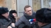 FILE - Russian opposition leader Alexei Navalny (C) is detained by police officers in Moscow, Jan. 28, 2018. 