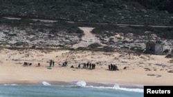 FILE - An aerial view shows Israeli soldiers cleaning tar from the sand after an offshore oil spill drenched much of Israel's Mediterranean shoreline, at a beach in Atlit, Israel, Feb. 22, 2021. 