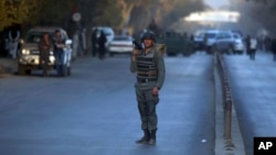 A policeman stands guard at the site of a suicide attack in central Kabul, Afghanistan, Oct. 31, 2017. 