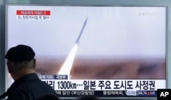 FILE - A man watches a TV screen showing a file footage of the missile launch conducted by North Korea, at Seoul Railway Station in Seoul, South Korea, Friday, March 18, 2016.