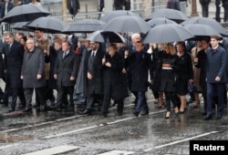French President Emmanuel Macron, his wife Brigitte, German Chancellor Angela Merkel, Canada's Prime Minister Justin Trudeau, and others arrive to attend a commemoration ceremony for Armistice Day, 100 years after the end of World War I, at the Arc de Triomphe, in Paris.