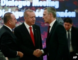 Turkey's President Recep Tayyip Erdogan, center, and Foreign Minister Mevlut Cavusoglu, left, speak with NATO Secretary General Jens Stoltenberg during a NATO's Mediterranean Dialogue, in Ankara, Turkey, Monday, May 6, 2019.