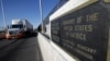 FILE - Trucks wait in the queue for border customs control to cross into the U.S., at the Bridge of the Americas, in Ciudad Juarez, Mexico, Aug. 15, 2017.