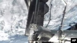 A NASA-TV image shows space shuttle Atlantis docked at the International Space Station, July 10, 2011