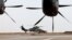 FILE - A French Eurocopter Tiger (Eurocopter EC665 Tigre) helicopter (L) takes off at the French Military base in Gao, Mali, Dec. 5, 2021.