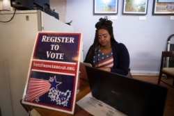 Le'Ana Freeman from Washington registers before casting vote on the Super Tuesday for U.S. Democrats Abroad multi-location global primary, at Foreign Correspondents' Club of Thailand in Bangkok, March 3, 2020.