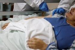 A resident receives a dose of the Pfizer-BioNTech COVID-19 vaccine at the Villa Verde elderly care home, as part of the coronavirus vaccination campaign in Rome, Italy, Jan. 7, 2021.