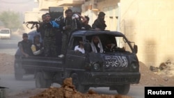 Free Syrian Army fighters on a pick-up truck, head towards the frontline where clashes with forces loyal to Syria's President Bashar al-Assad are taking place, in Damascus May 5, 2013. 