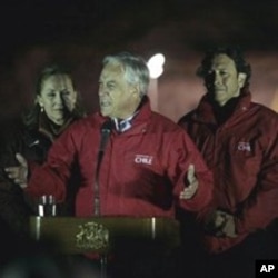 Chile's President Sebastian Pinera, center, first lady Cecilia Morel, left, and Mining Minister Laurence Goldburn, right, talk to the press after the rescue of the first of 33 trapped miners at the San Jose Mine near Copiapo, 13 Oct. 2010