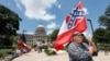Supporters of the current Mississippi state flag stand outside the state Capitol in Jackson, Mississippi, June 28, 2020.