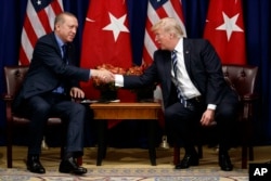 U.S. President Donald Trump shakes hands with Turkish President Recep Tayyip Erdogan during a meeting at the Palace Hotel during the United Nations General Assembly in New York, Sept. 21, 2017.