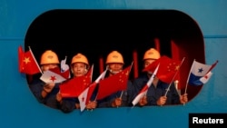 FILE - Sailors wave the China and Panama flags to China's President Xi Jinping at the Cocoli locks in the expanded Panama Canal, in Panama City, Panama, Dec. 3, 2018.