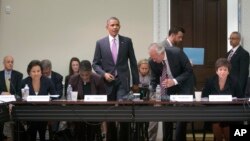 President Barack Obama, center, takes his seat before speaking to members of his Export Council during their meeting in the Eisenhower Executive Office Building on the White House complex, Sept. 19, 2013.