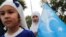 FILE - An ethnic Uyghur girl holds an East Turkestan flag during a protest against China in Istanbul, Turkey, Aug. 31, 2022. This month marks two years since the U.S. formally recognized China's mistreatment of Uyghurs and other Turkic Muslim populations in Xinjiang as genocide.