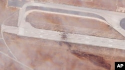 This satellite photo shows run damage after an Israeli strike targeted the Aleppo International Airport, Sept. 1, 2022. The attack also damaged a nearby piece of tarmac and a structure on the military side of the Syrian airport. (Planet Labs PBC via AP)