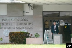 A security guard stands outside the Paul G. Rogers Federal Building and U.S. Courthouse, in West Palm Beach, Fla., Sept. 1, 2022.