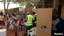 A man prepares to cast his ballot at a polling station during the second round of Guinea Bissau's presidential election in Bissau, Guinea-Bissau, Dec. 29, 2019.