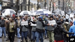 Protesters make their way up North Michigan Avenue on Friday, Nov. 27, 2015, in Chicago.