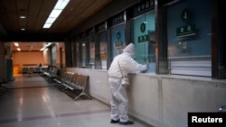 A woman wearing protective suit is seen at a hospital after the lockdown was lifted in Wuhan, capital of Hubei province and China's epicentre of the novel coronavirus disease (COVID-19) outbreak, April 13, 2020. 