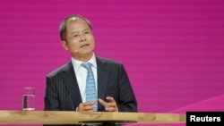 FILE - Eric Xu, CEO of Huawei, addresses media at Cebit, the world's biggest computer and software fair, in Hanover, Germany, March 14, 2016. 