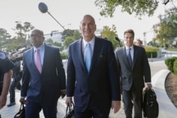 FILE - U.S. Ambassador to the European Union Gordon Sondland, center, arrives for an interview with the House Foreign Affairs, Intelligence and Oversight committees on Capitol Hill in Washington, Oct. 17, 2019.