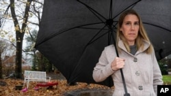 Claire Tillberg, stands for a portrait outside her family's home, Monday, Nov. 23, 2020, in a Boston suburb. Her 11-year-old daughter with mental health issues has struggled to get care.