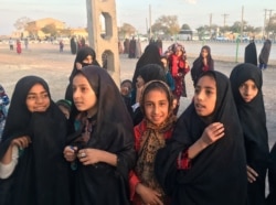 FILE - Afghan refugee girls gather at the Bardsir settlement for Afghan refugees in Kerman province, Iran, Oct. 22, 2016.