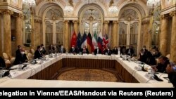 FILE - Officials wait for the start of a meeting of the JCPOA Joint Commission in Vienna, Dec. 9, 2021. 