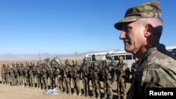 FILE - U.S. Army General John Nicholson, commander of Resolute Support forces and U.S. forces in Afghanistan, speaks with Afghan police special forces after they took part in a military exercise in Logar province, Afghanistan, Nov. 30, 2017.