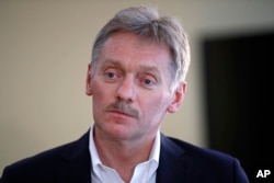 President Vladimir Putin's spokesman Dmitry Peskov speaks with The Associated Press in Moscow, April 6, 2017. Peskov, speaking days after a suspected chemical weapons attack, says Russia's support for Syrian President Bashar Assad is not unconditional.