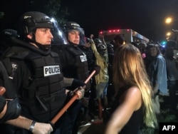 Police gather around protestors following the fatal police shooting of a black man, with a dozen officers and several demonstrators injured in the violence on Sept. 20, 2016 in Charlotte, North Carolina.