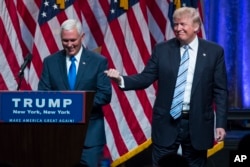 Republican presidential candidate Donald Trump, right, introduces Gov. Mike Pence, R-Ind., during a campaign event to announce Pence as the vice presidential running mate on, Saturday, July 16, 2016, in New York.