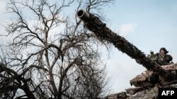 A Ukrainian serviceman rides on a battle tank in Bakhmut, eastern Ukraine, Feb. 5, 2023.
