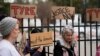 A group of demonstrators protest outside a police precinct in response to the death of Tyre Nichols, who died after being beaten by Memphis police officers, in Memphis, Tenn., Jan. 29, 2023.