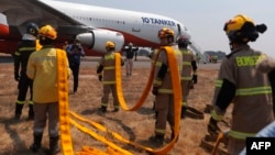 Firefighters prepare to load water into the US DC-10 Air Tanker at the Carriel Sur airport in Concepcion, Chile on Feb. 6, 2023.