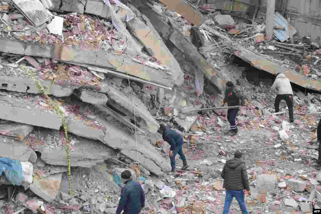 Rescue workers and volunteers conduct search and rescue operations in the rubble of a collasped building, in Diyarbakir, Turkey, Feb. 6, 2023.