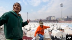 FILE - Children play where tents have been set up for earthquake survivors, in Kharamanmaras, Turkey, Feb. 10, 2023. A gate between long-feuding Turkey and Armenia has been opened for the first time in 35 years to bring in aid, according to the state-owned Anadolu news agency.