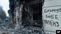 The city center in Bakhmut, Donetsk region, Ukraine, was damaged by Russian shelling, Feb. 10, 2023. The writing on the wall reads "Bakhmut loves Ukraine."