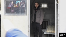 Oleg Navalny, the brother of Alexei Navalny, poses on Jan. 24, 2023 inside of a mockup of the prison cell of jailed Russian opposition politician Alexei Navalny, in front of the Russian embassy in Berlin.
