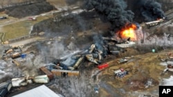 This photo taken with a drone shows portions of a Norfolk and Southern freight train that derailed Friday night in East Palestine, Ohio are still on fire at mid-day Saturday, Feb. 4, 2023.