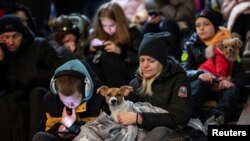 People take shelter inside a metro station during massive Russian missile attacks in Kyiv, Ukraine, Feb. 10, 2023.