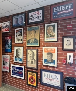 Campaign posters from past presidential primaries hang on a wall at the New Hampshire Institute of Politics at Saint Anselm College in Manchester. (Steve Herman/VOA News)