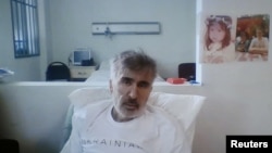 Georgia's jailed ex-President Mikheil Saakashvili is seen via a video link from a clinic during a court hearing to consider a request to release him or defer his six-year sentence for abuse of power over health concerns, in Tbilisi, Georgia, Feb. 1, 2023.
