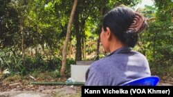 Sopheap sits as she recalls her experience of physical and emotional abuses by her husband, in Kampong Chhnang, on December 26, 2022. 