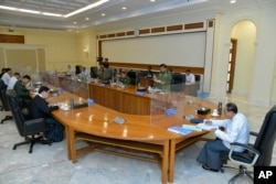 Myint Swe, right, acting president of the military government, attends a meeting with members the National Defense and Security Council in Naypyitaw, Myanmar, Jan. 31, 2023, in this photo released from the The Military True News Information Team.